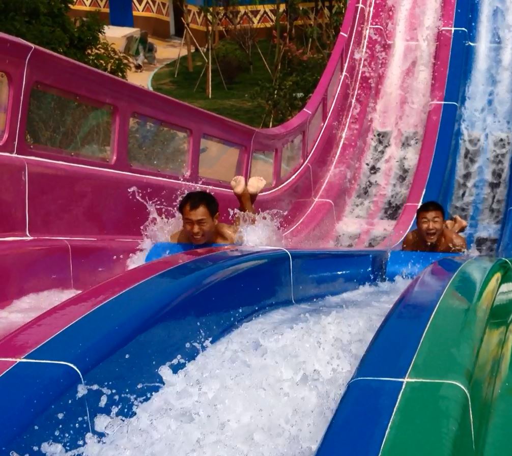 Competitors on a Mat Blaster racing water slide