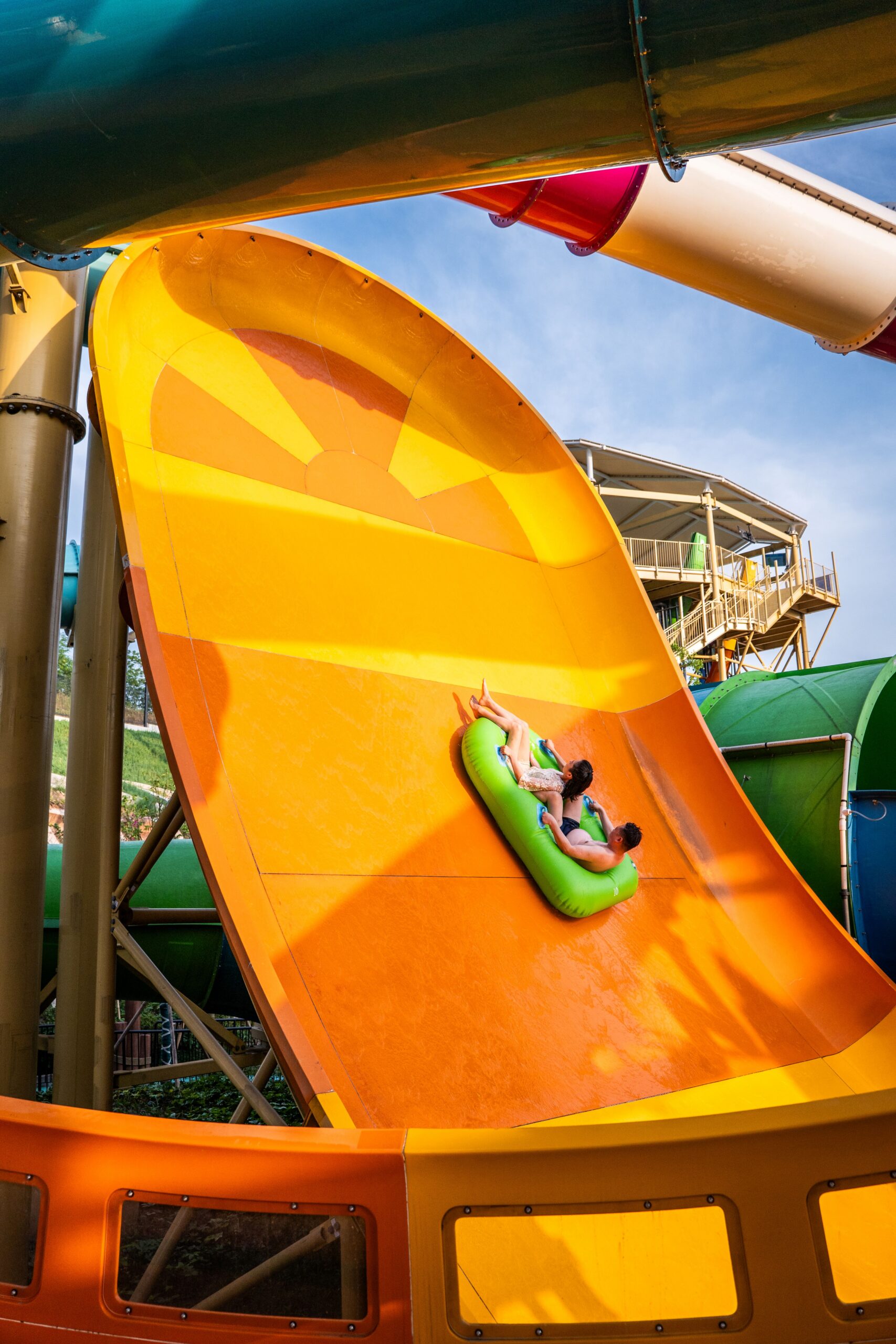 Rider in an inner tube going up a Boomerango water slide wall