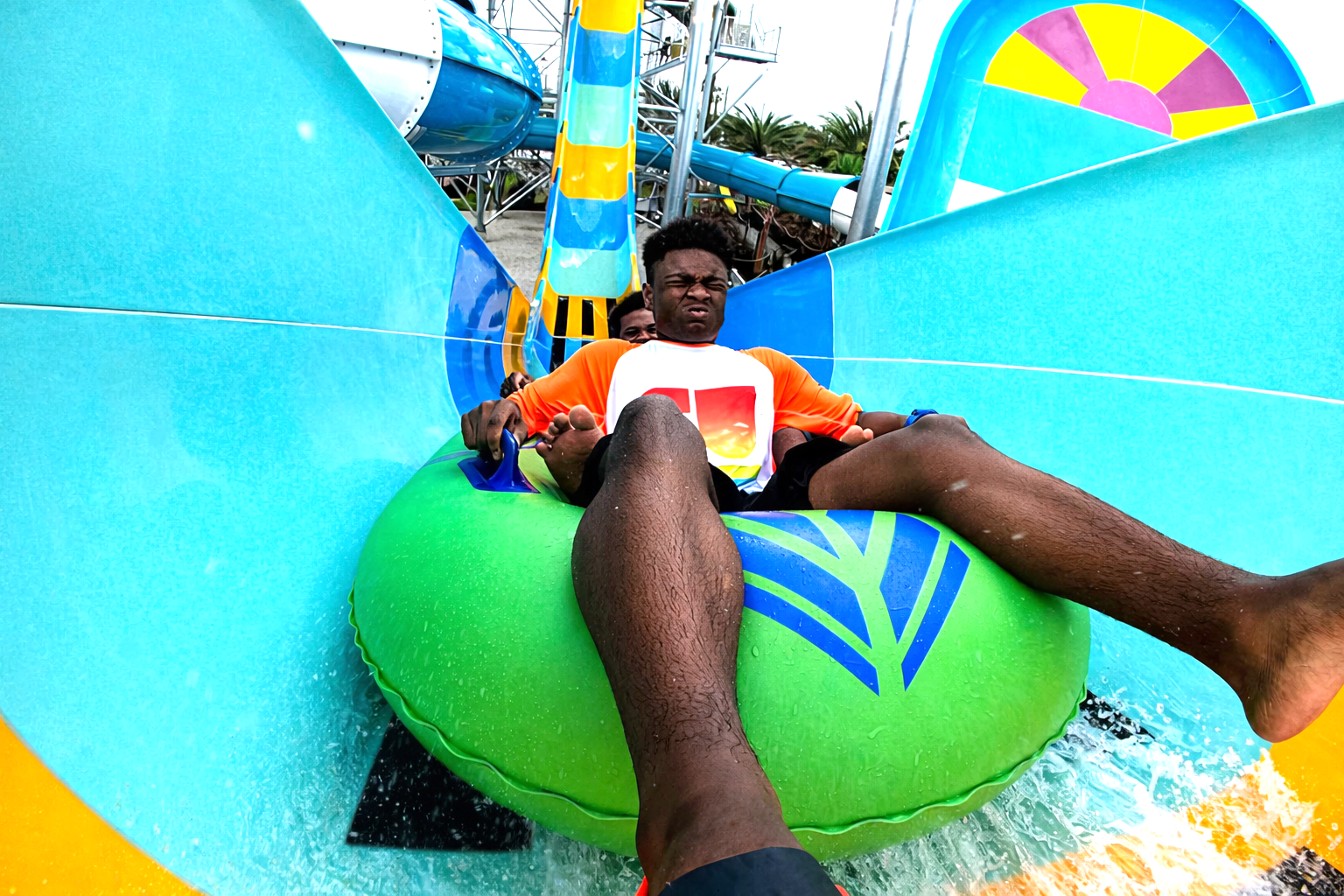 Two guys in an inner tube blasting up on a water coater