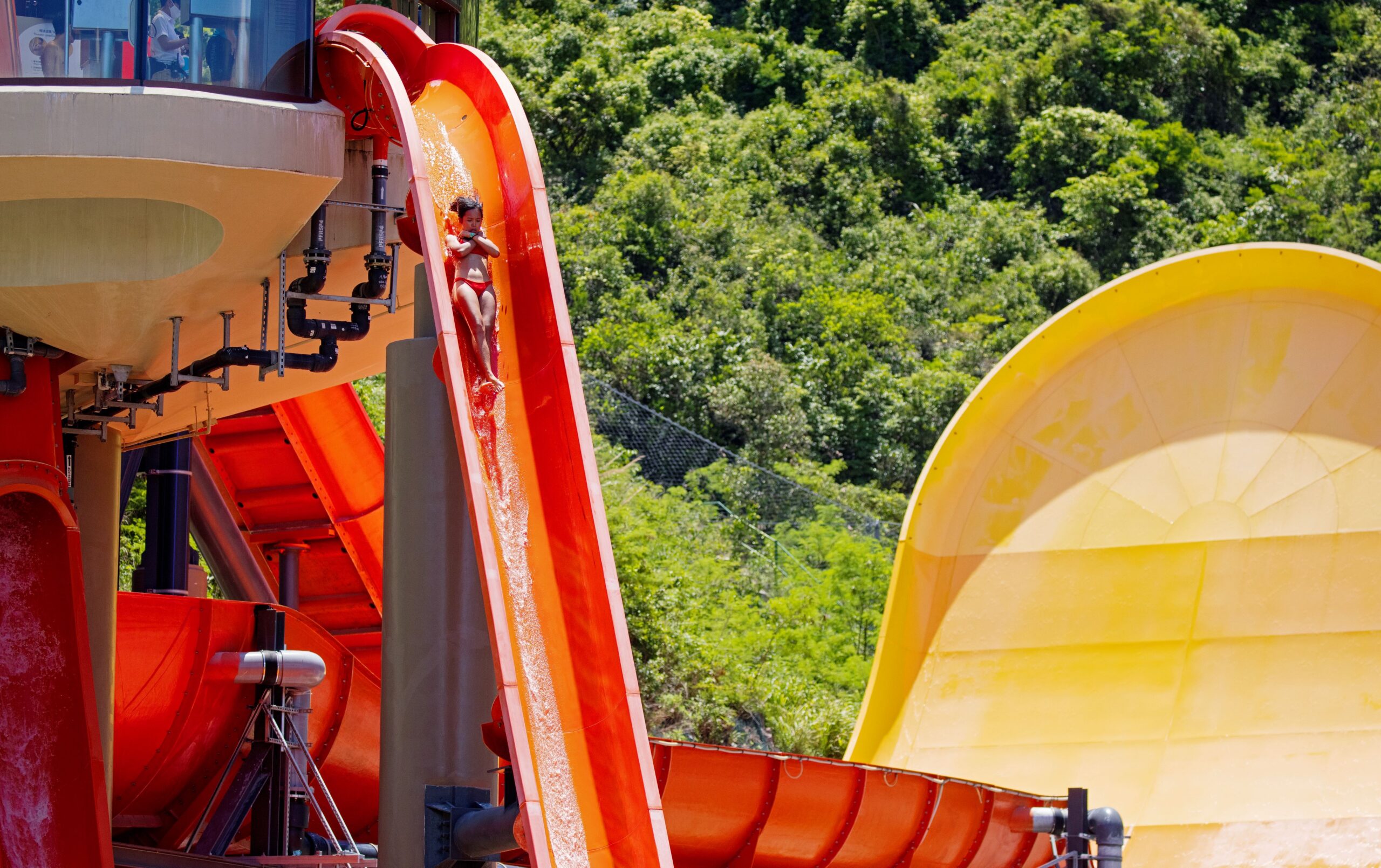 A rider going down an orange freefall water slide