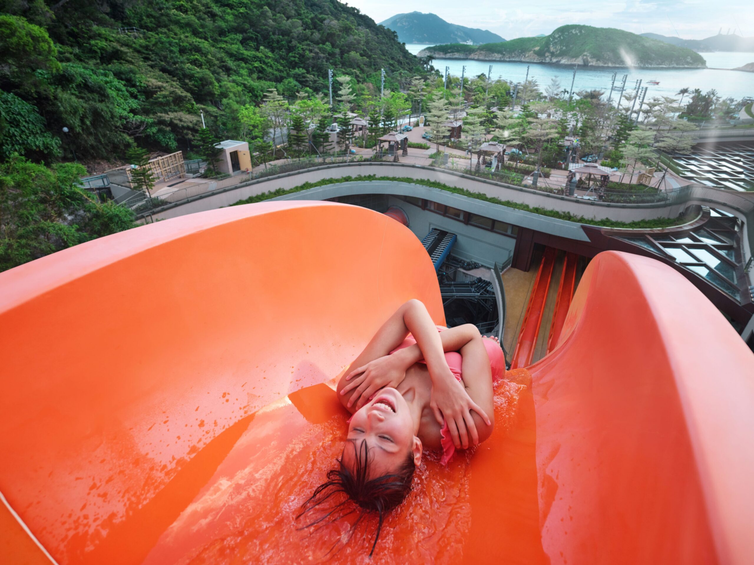 A rider going down an orange freefall water slide