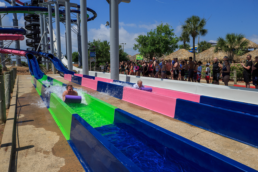 Two riders on a mat racer water slide