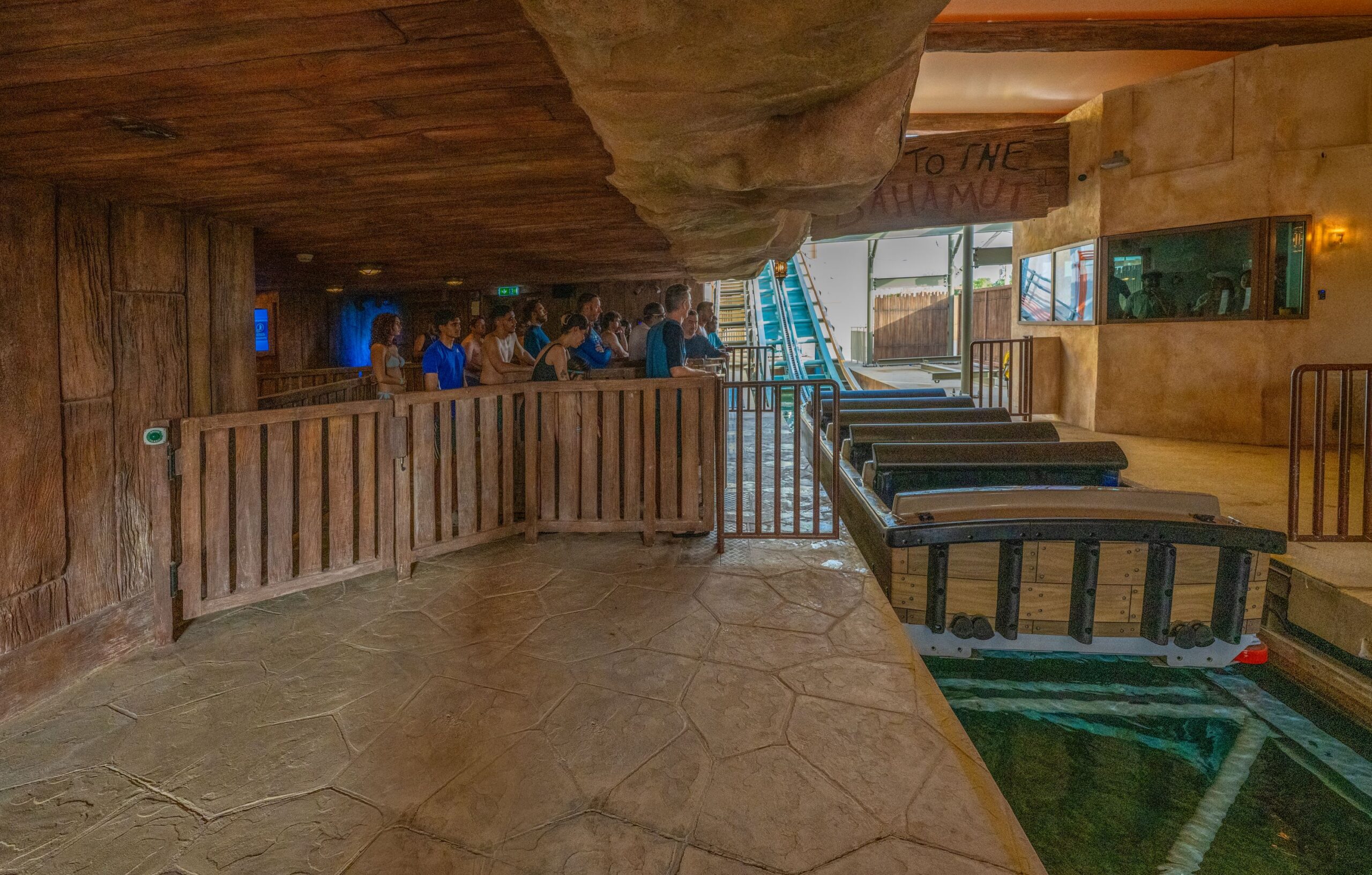 Riders standing in line ready to board a Shoot the Chute boat