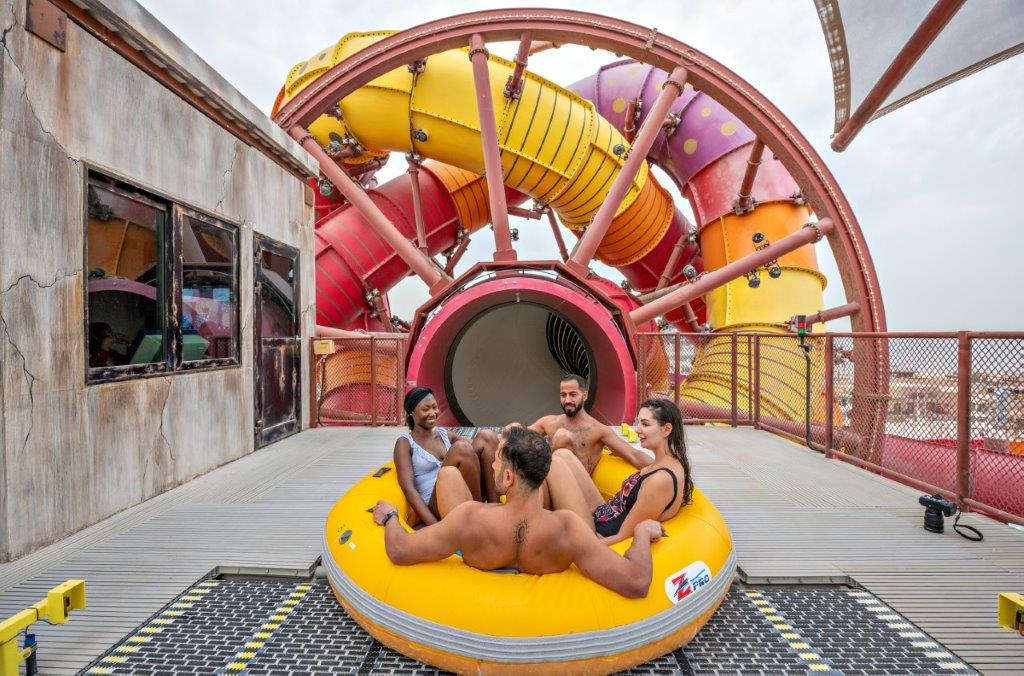 Four riders in a raft launching into a SlideWheel