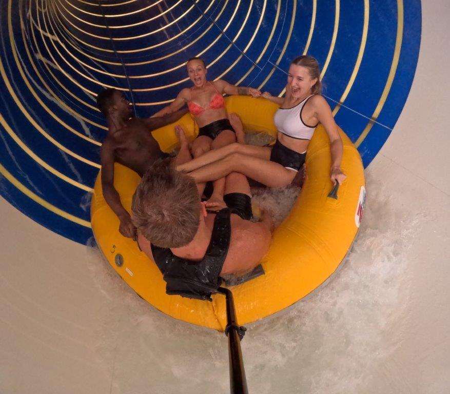 Four riders in a raft inside a SlideWheel