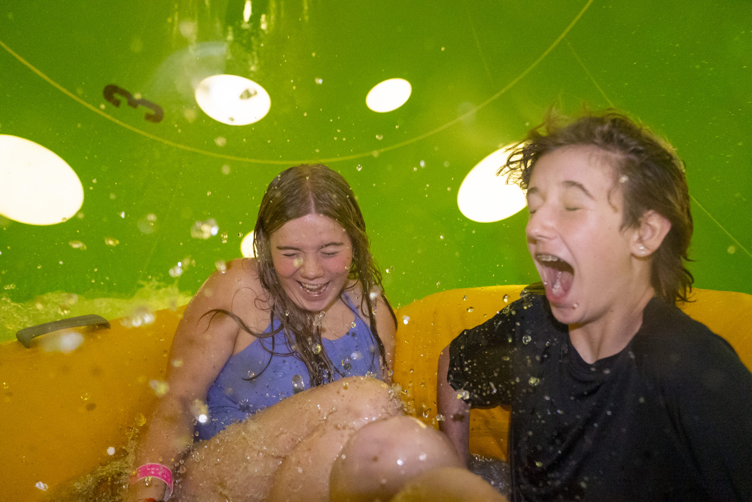 Two riders laughing inside the SlideWheel
