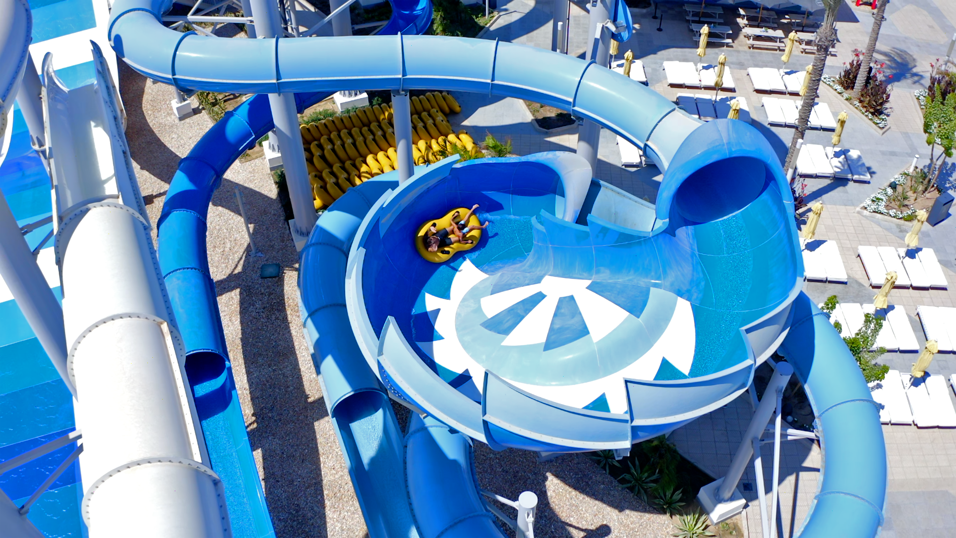 Rider in an inner tube inside a bowl-like water slide