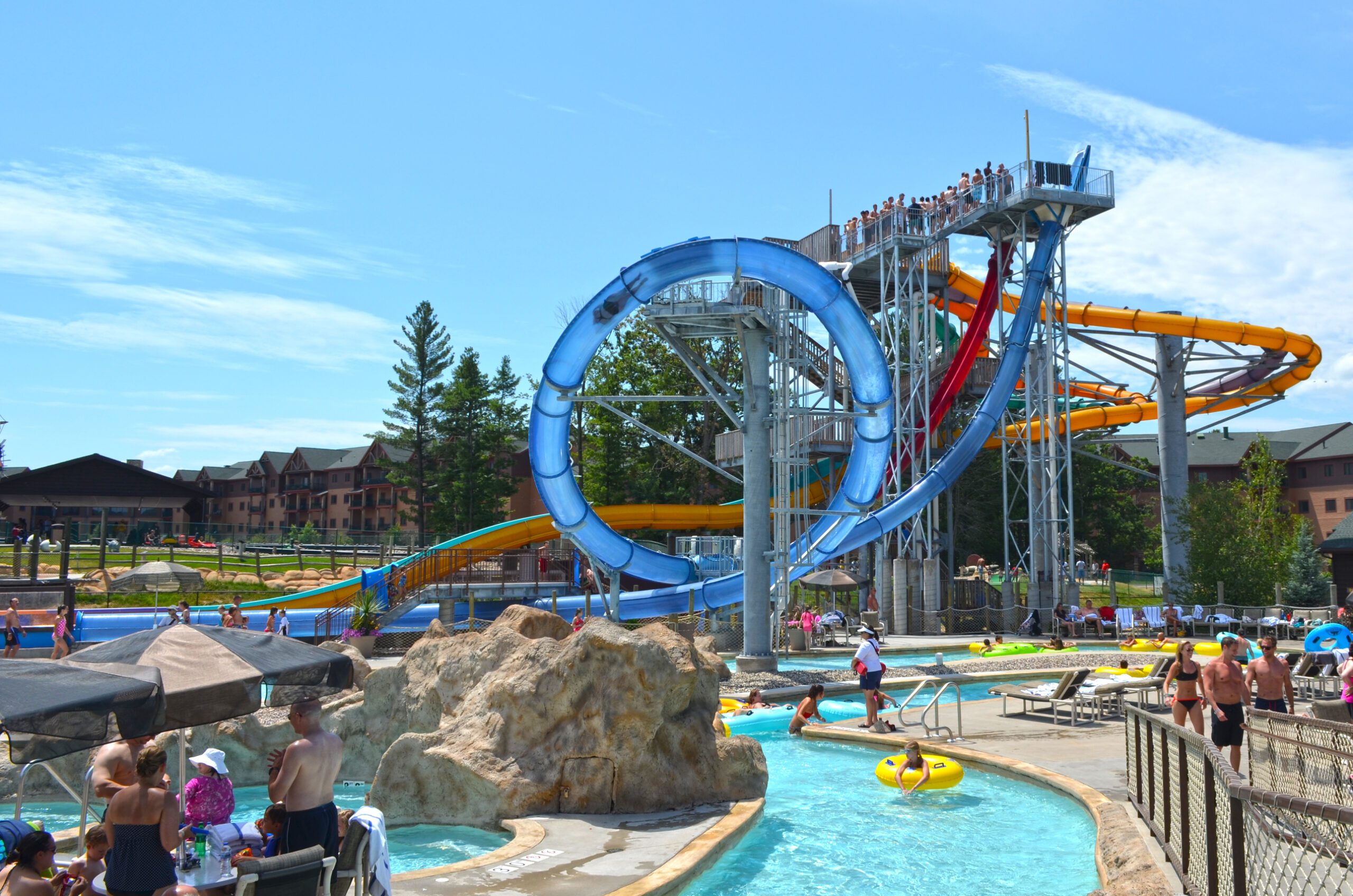 A water park featuring a translucent water slide flume in a 360-degree inclined loop