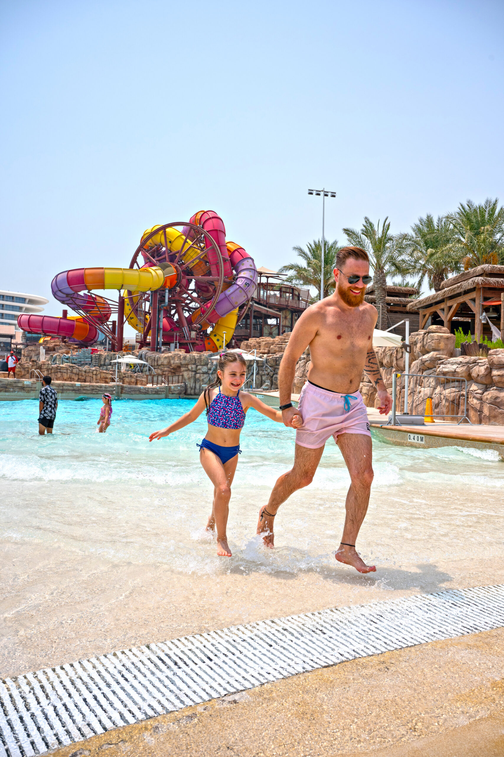 Father and daughter enjoying wave pool
