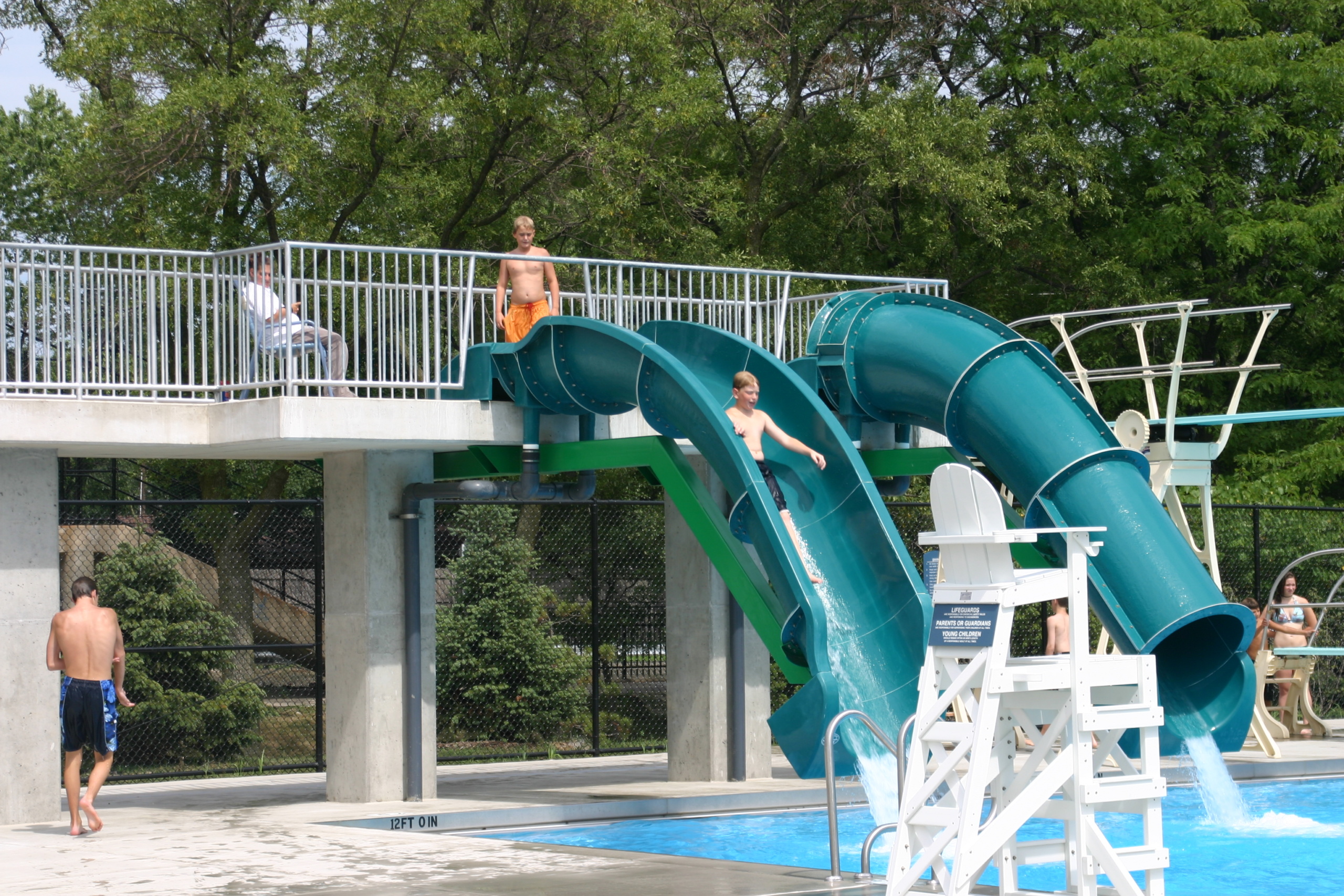 Simple water facilities for everyone. A boy is going to slide into the water