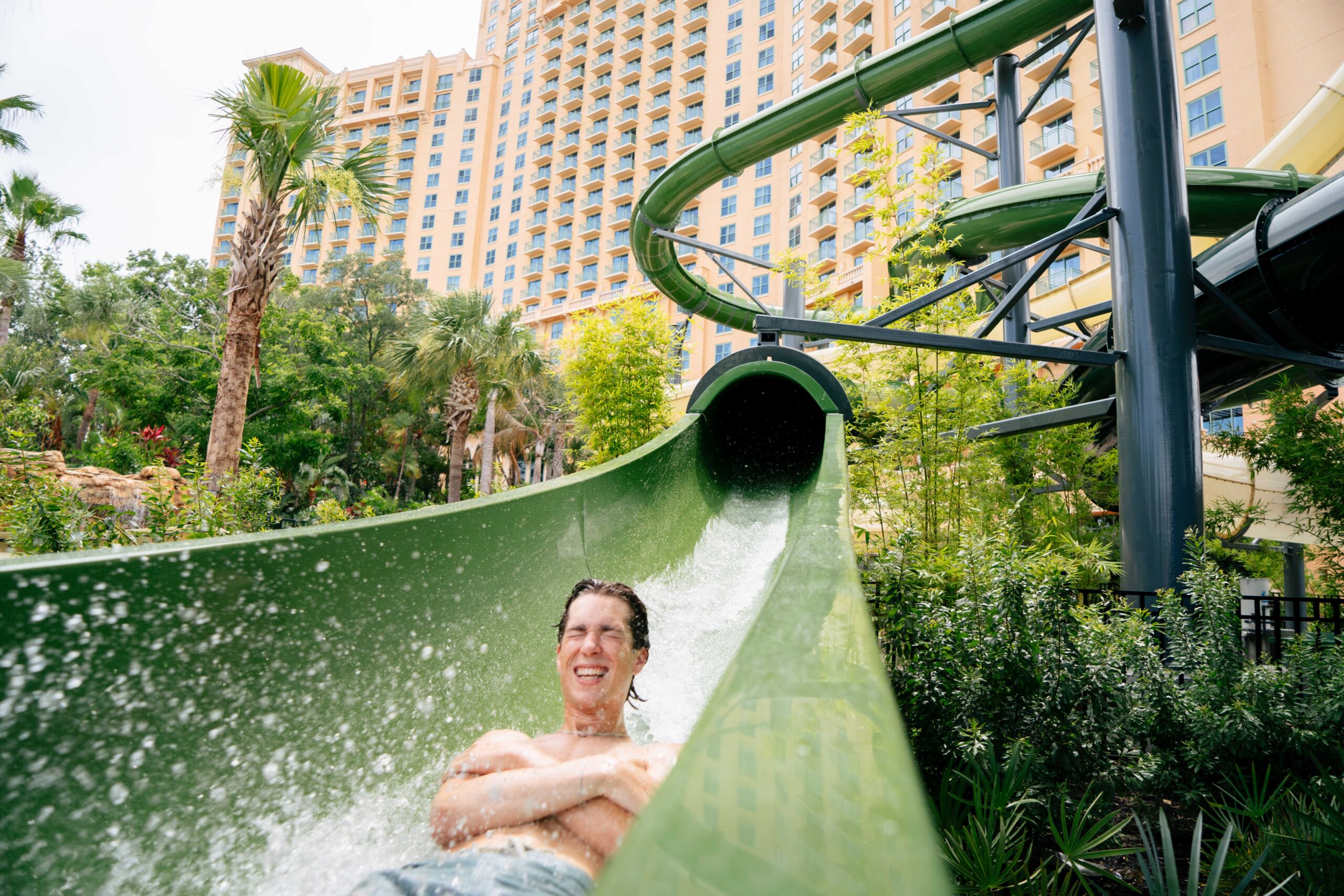 A young man going down a hotel water slide