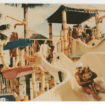 Early people playing on water slides