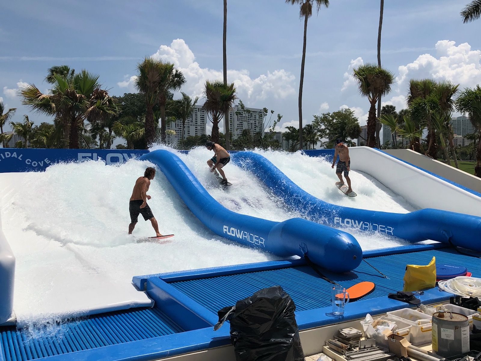 Three men water skiing on surfboards