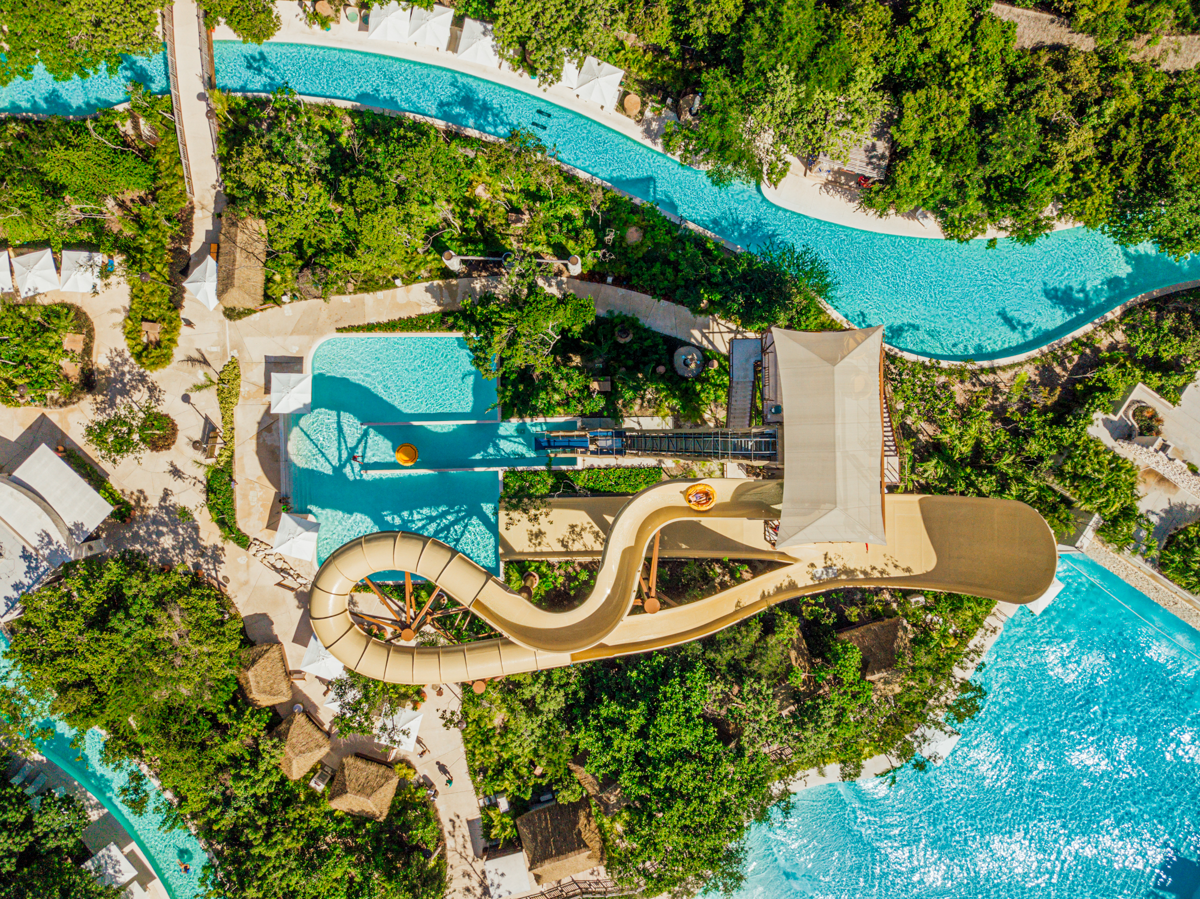 water slide and tower in lush green from bird's eye view