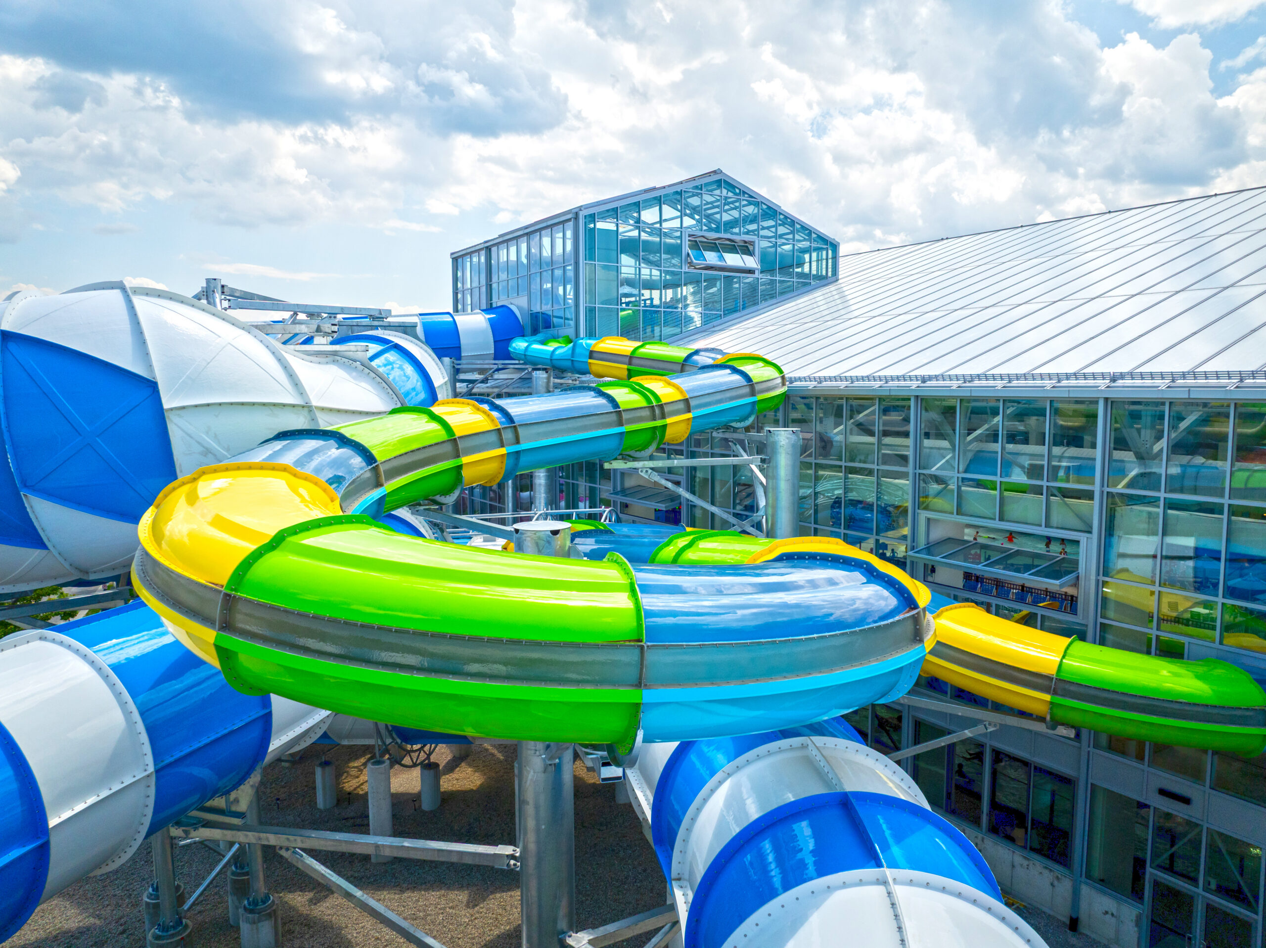Water slides protruding outside an indoor water park