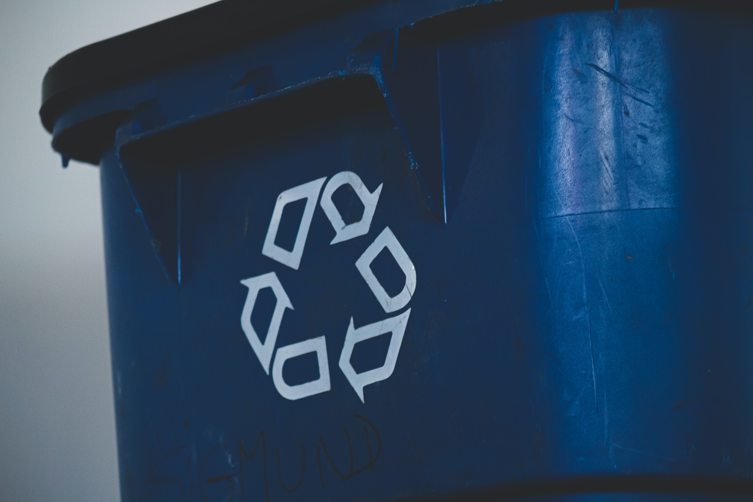 A trash can with a recycling symbol