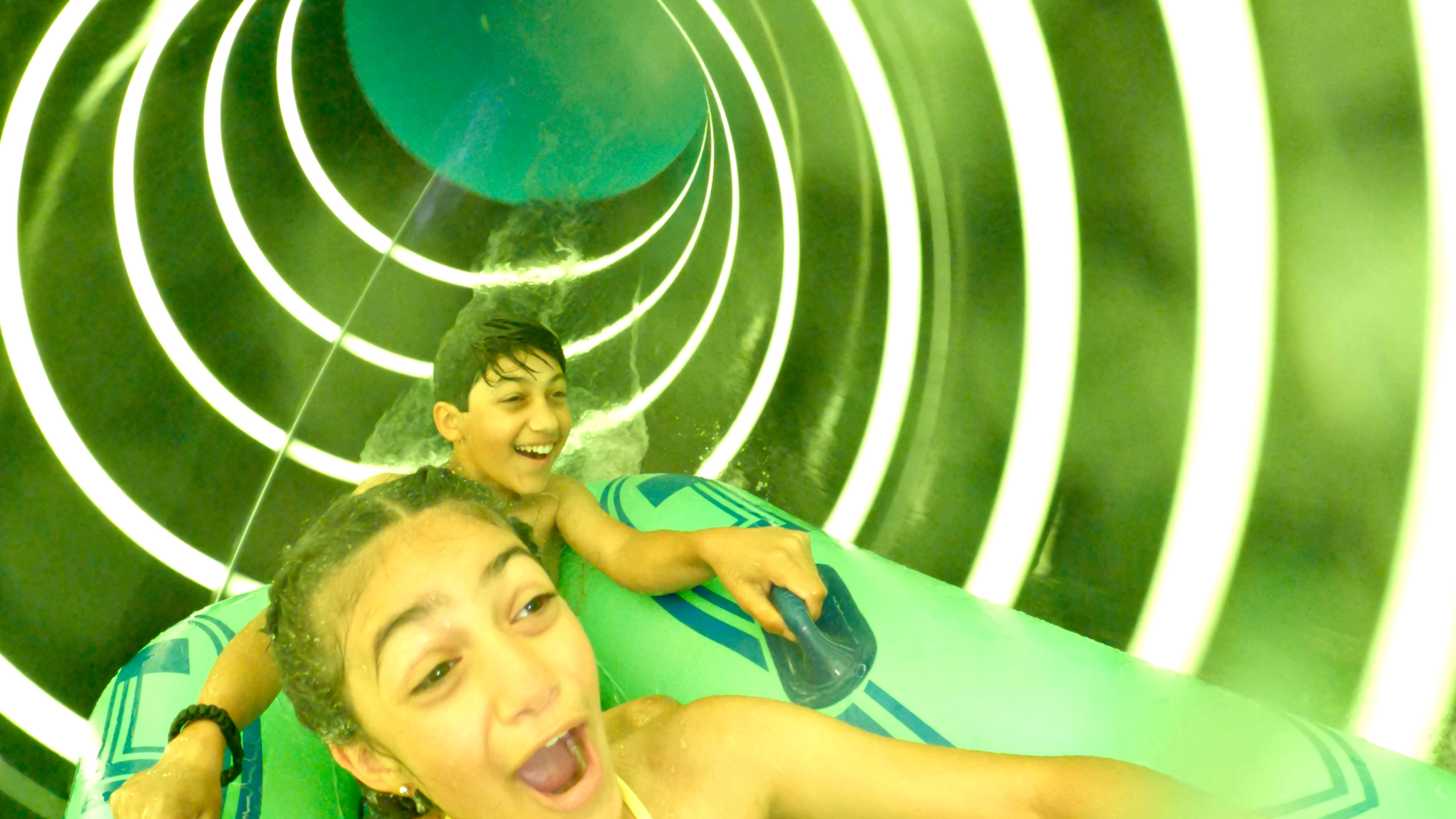 Children in water slide tube with AquaLucent rings