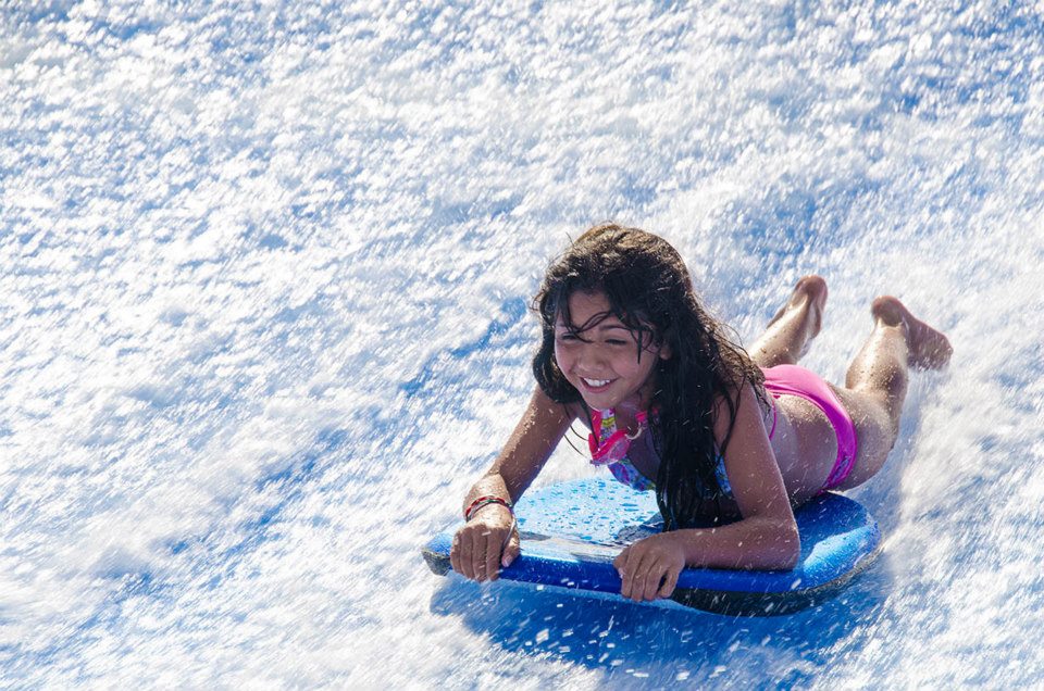 Girl on FlowRider flowboard