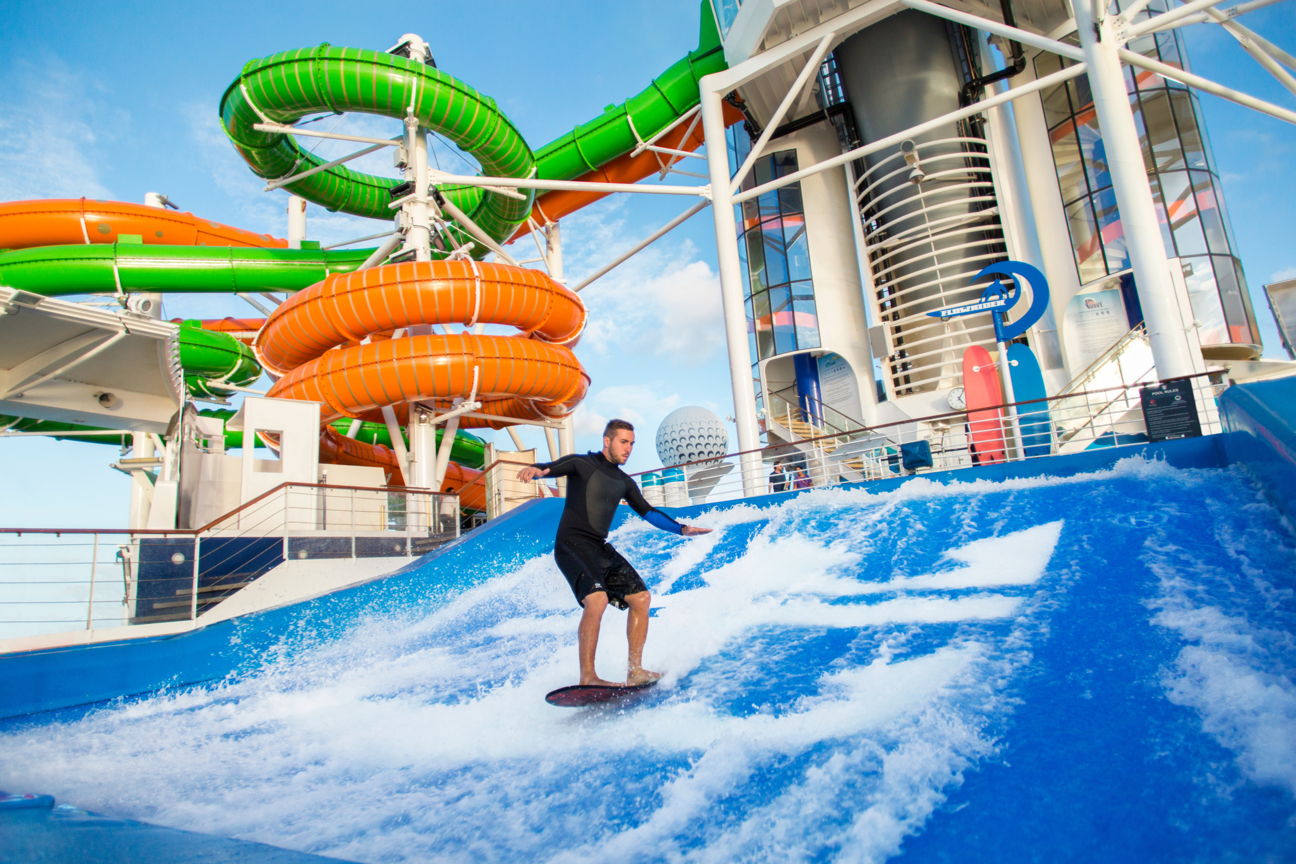Surfer on FlowRider on the back of Liberty of the Seas cruise ship