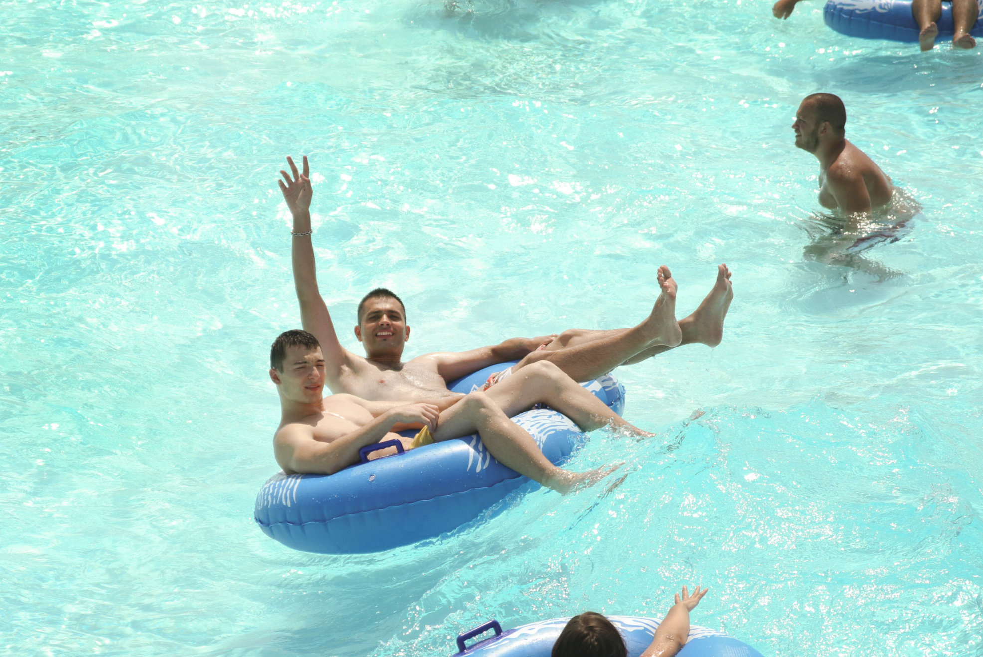 Guests enjoying a wave pool on inner tubes