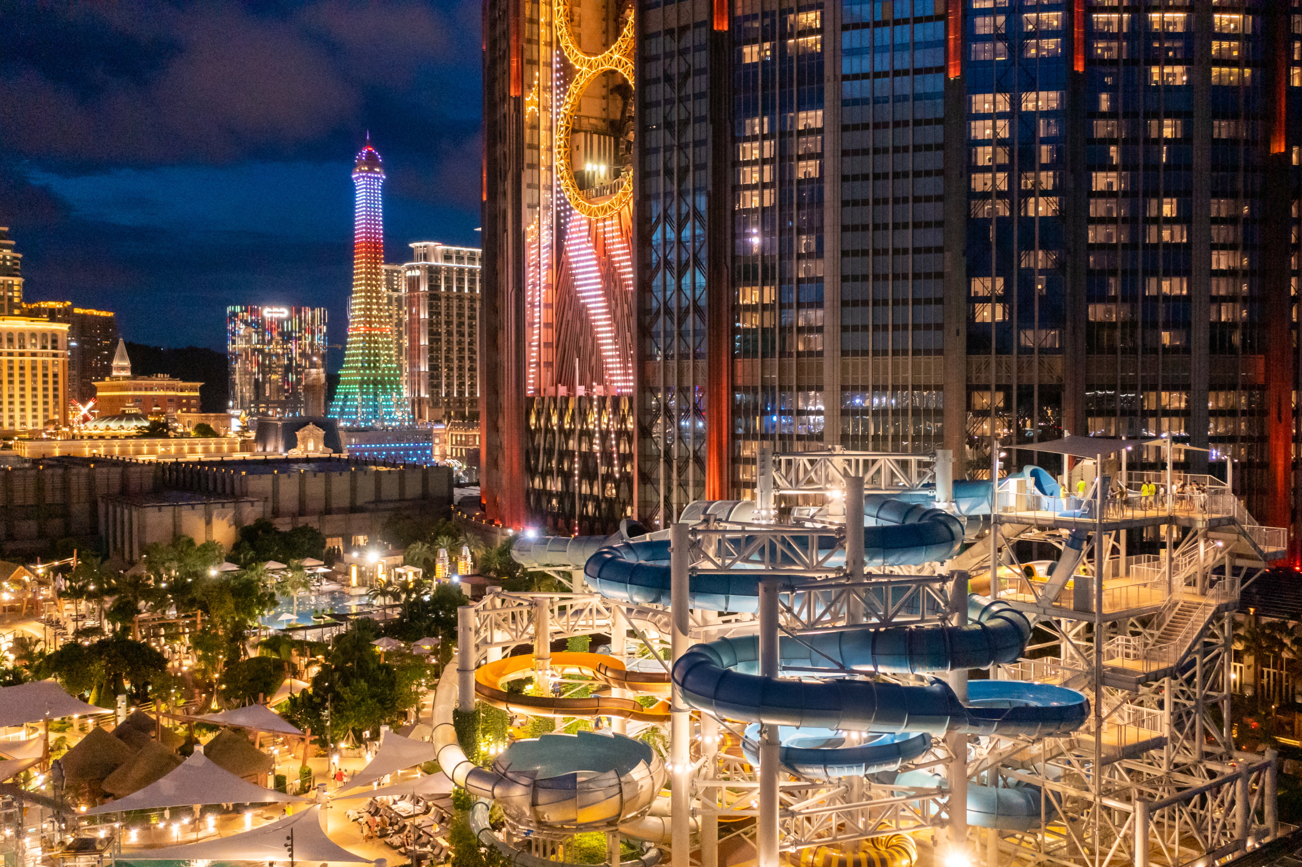 Water park at night against city backdrop