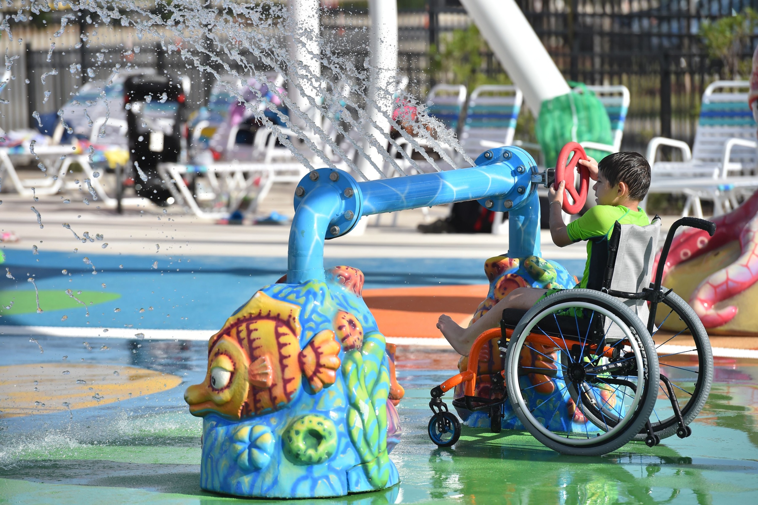 Boy in wheelchair playing inside water park