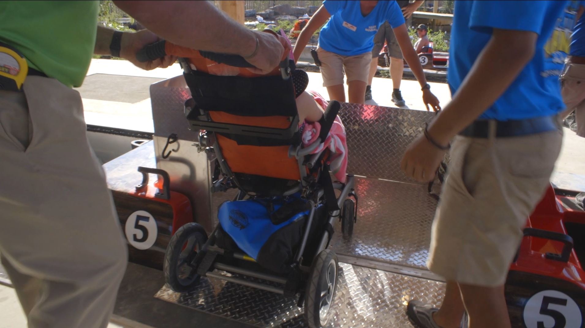Loading wheelchair onto water ride