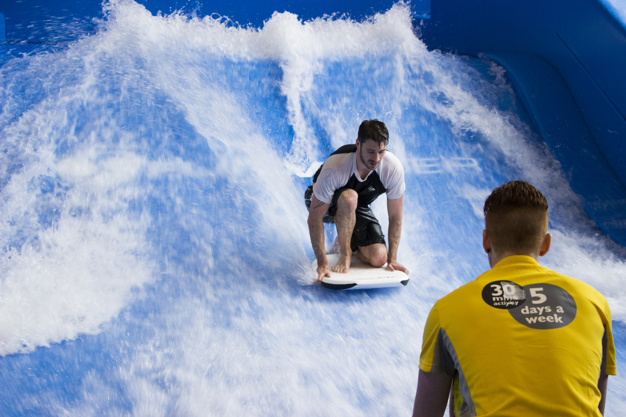 Surfer attempting to stand up while on FlowRider