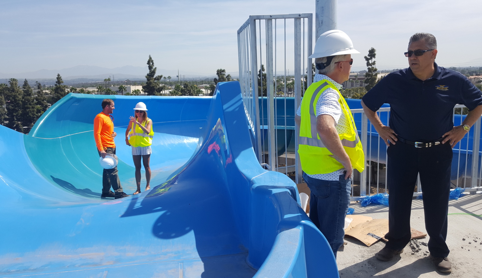 People walking a water slide to inspect