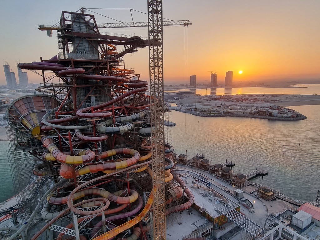 Tower with 12 water slides against the sea and setting sun