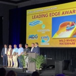 People standing on stage receiving award