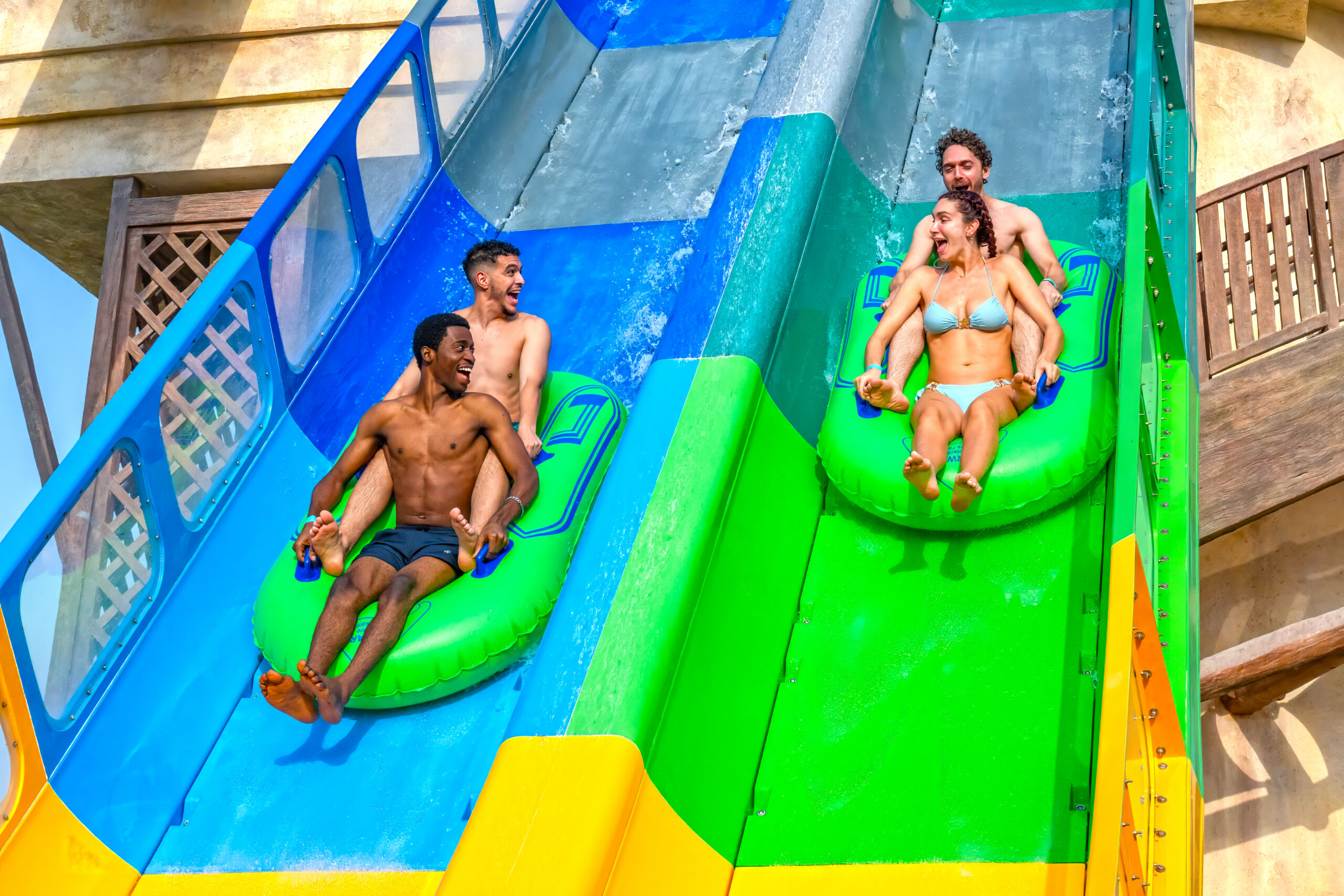 Two inner tubes going down a water coaster side by side