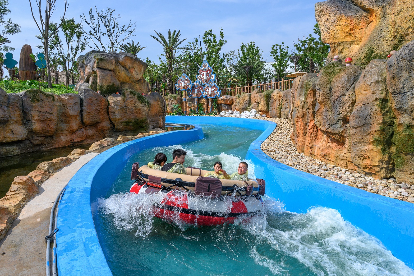 Four people in a Spinning Rapids Ride boat in a river