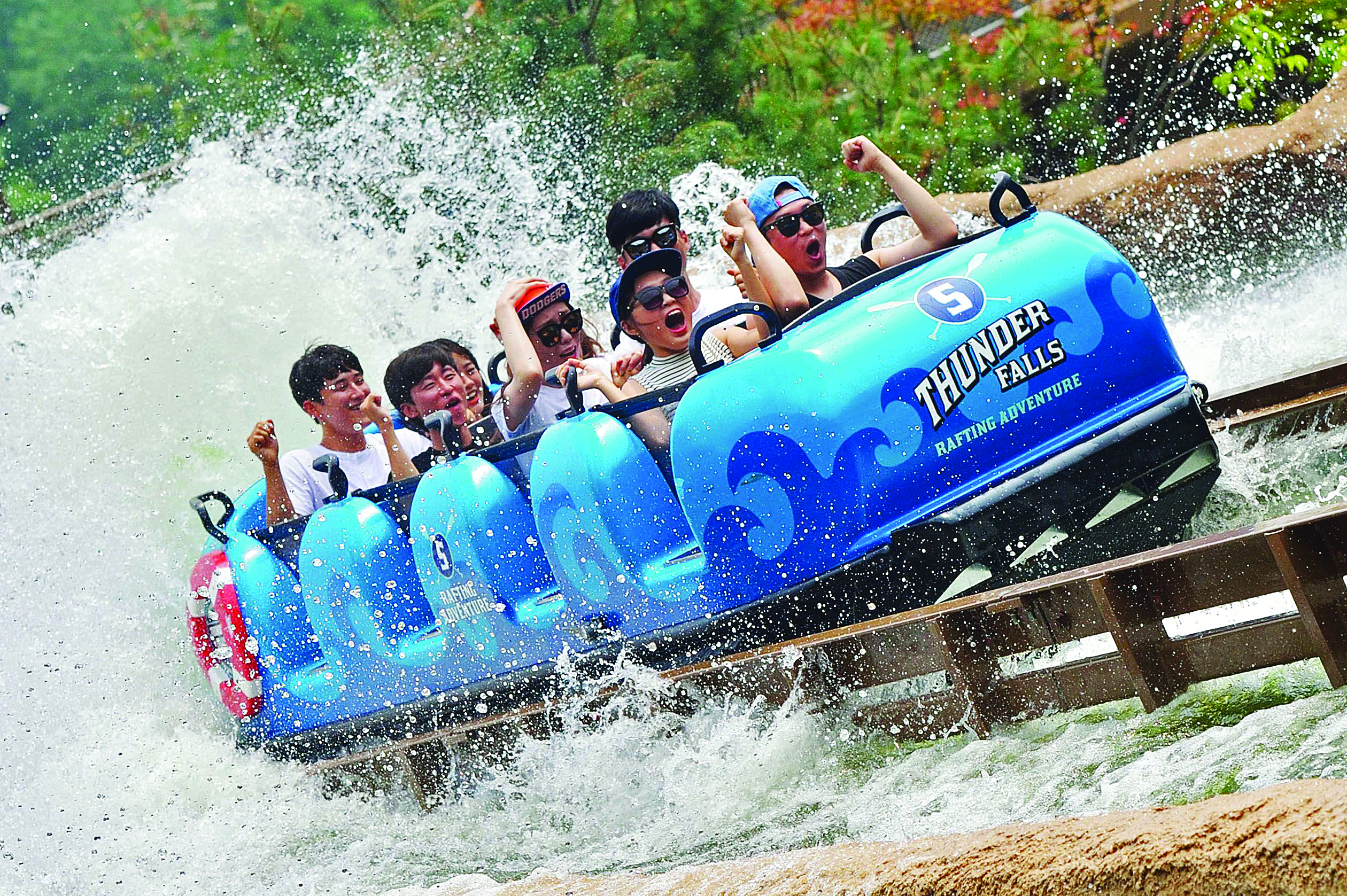 people on blue super flume water ride with splash