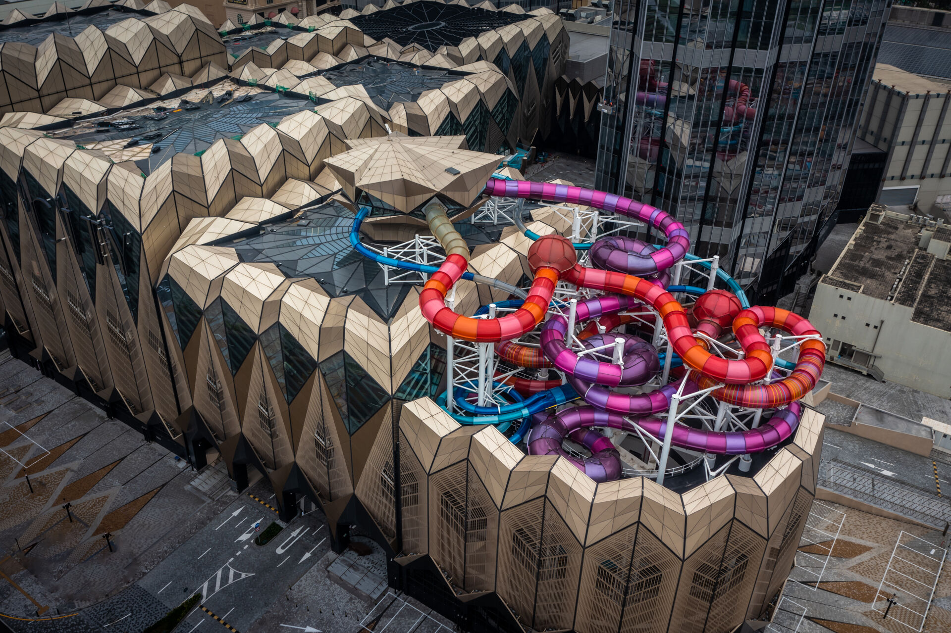 Facade of an indoor water park with protruding metallic colored water slides