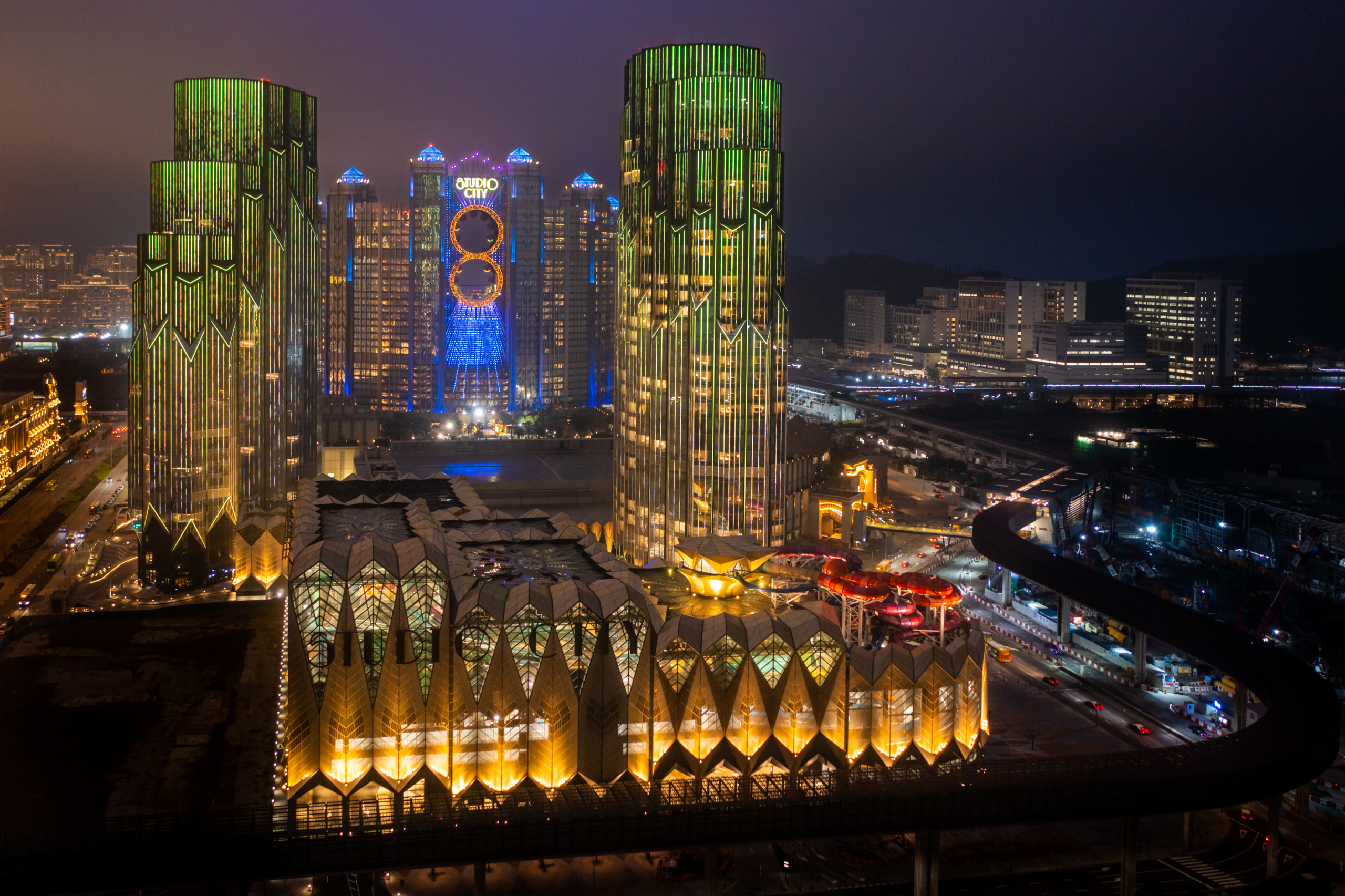 Picture of glitzy buildings at night with water park in the complex