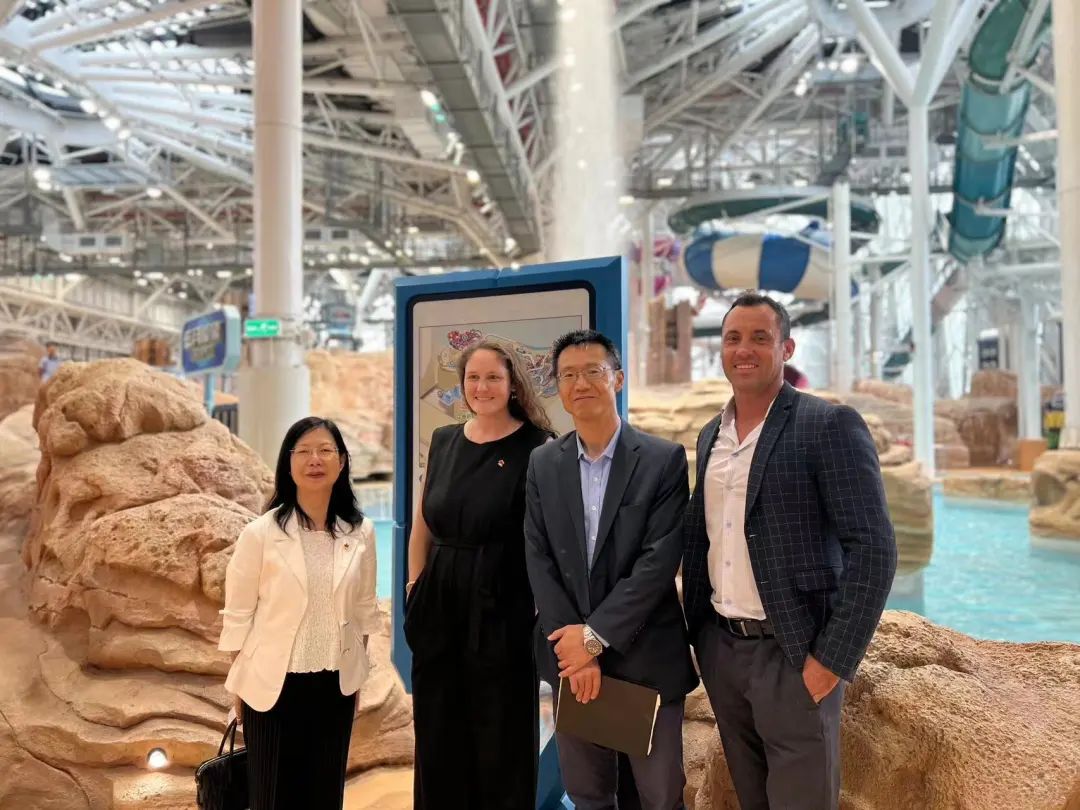 Two women and two men posing inside indoor water park grand opening