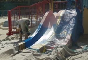 Man painting a water slide