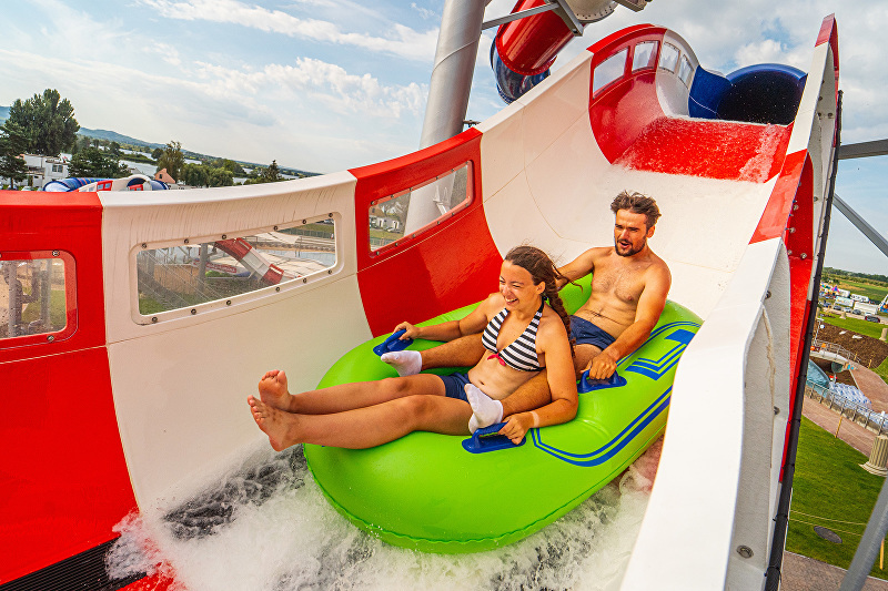 A man and a woman on an inner tube riding a Master Blaster water coaster