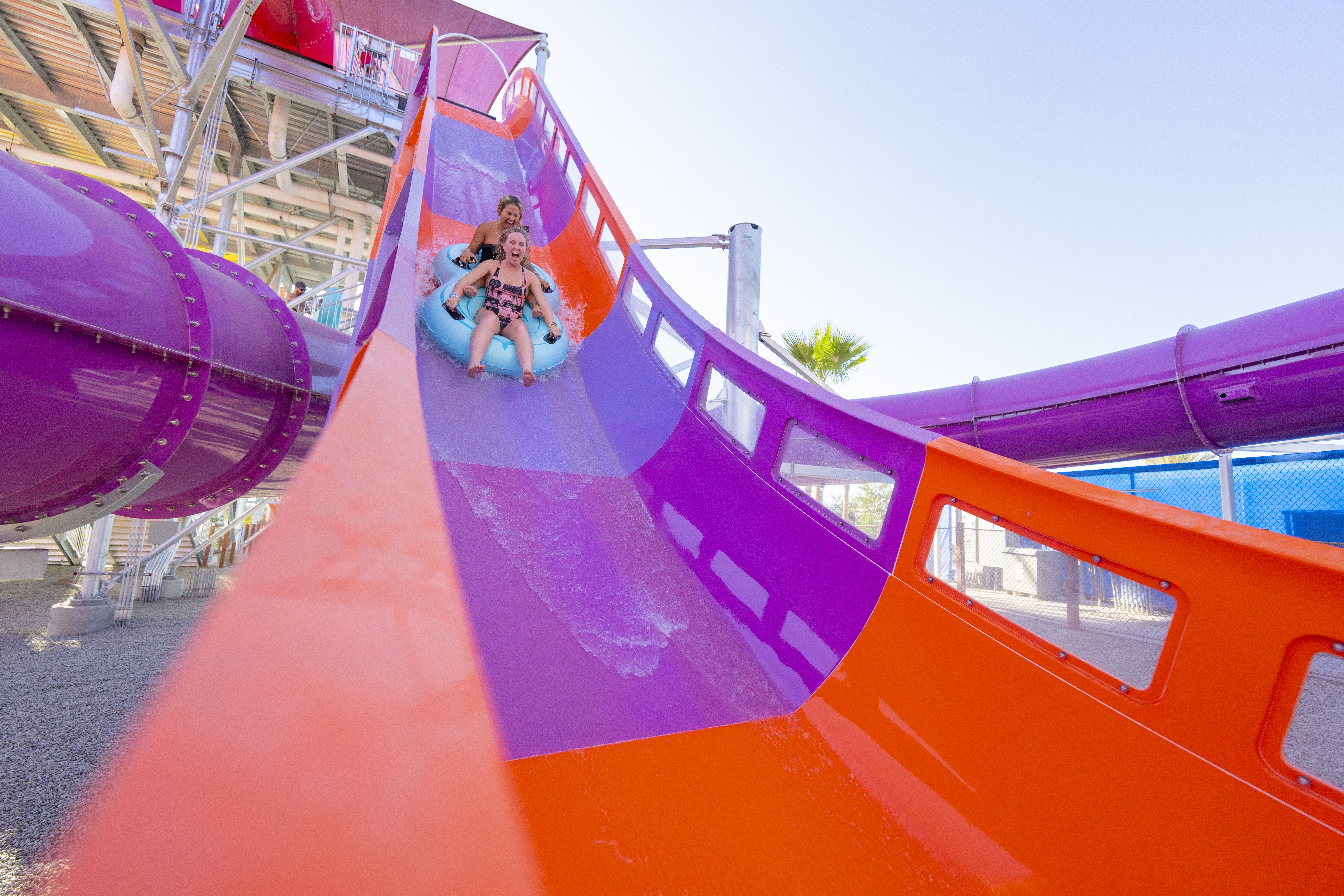 An inner tube with riders going down a water coaster