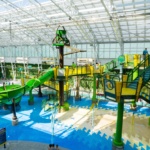 A multi-level aquatic play structure at an indoor water park