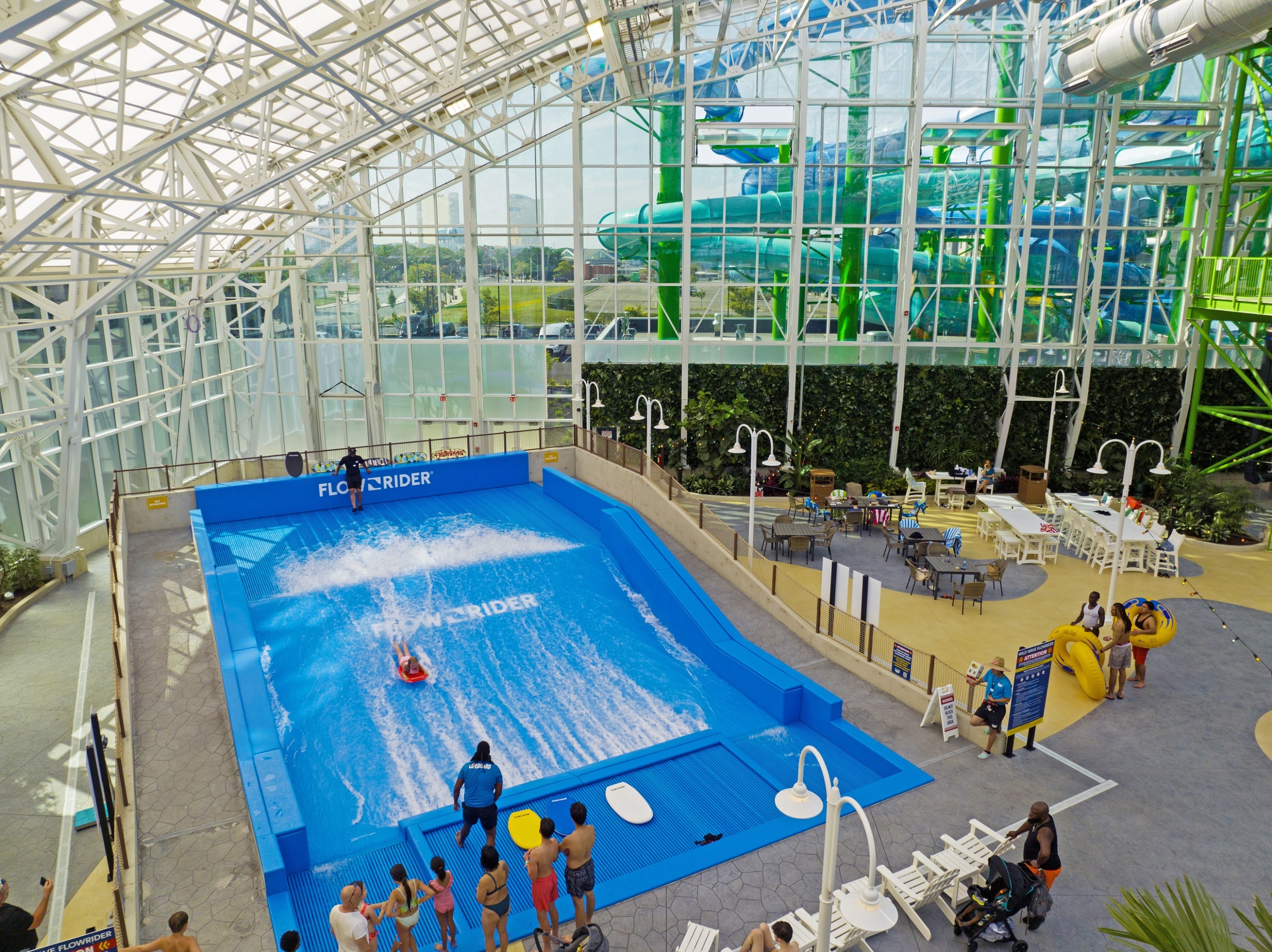 People looking at person on surf machine at an indoor water park