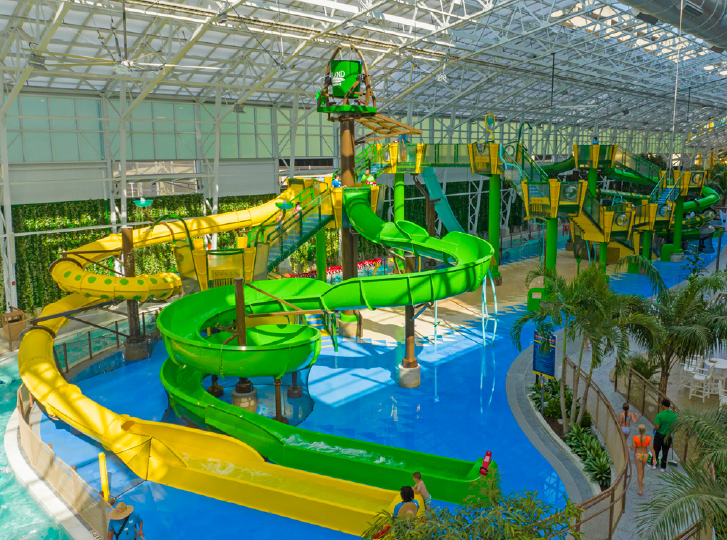 Elevated AquaForms aquatic play structure in green and yellow
