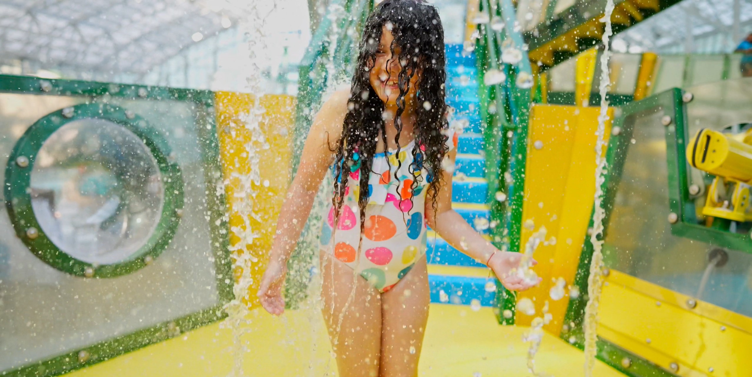 Child playing at interactive aquatic play structure