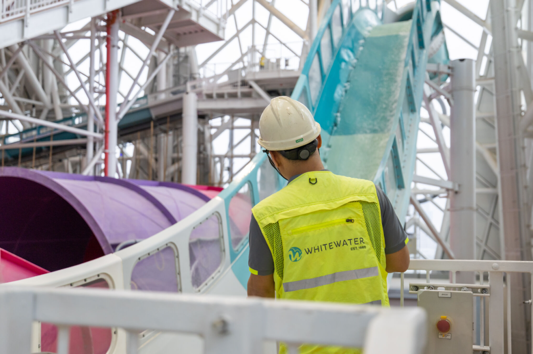 Water park maintenance guy looking at water slide