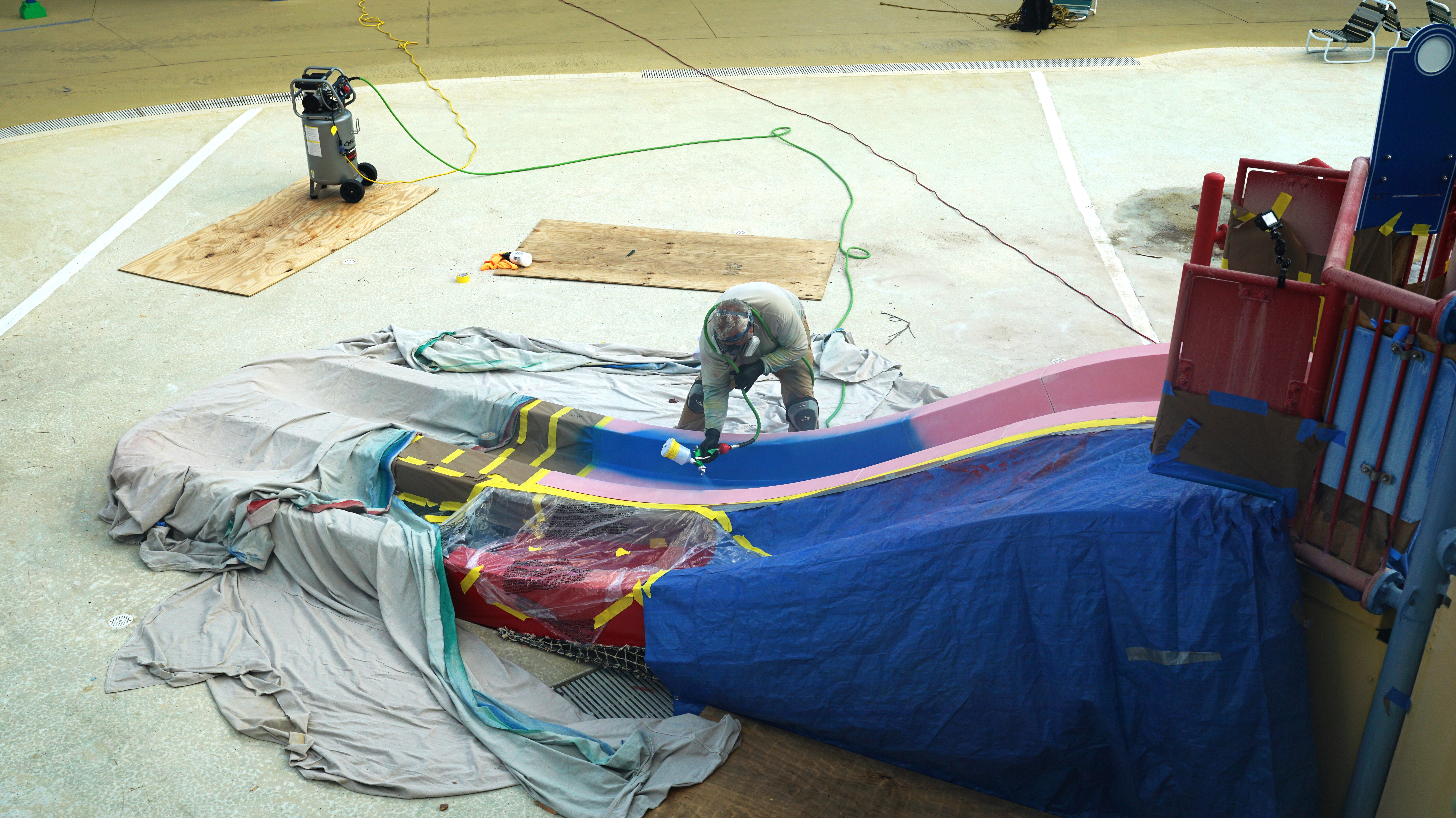 Man repainting a water slide