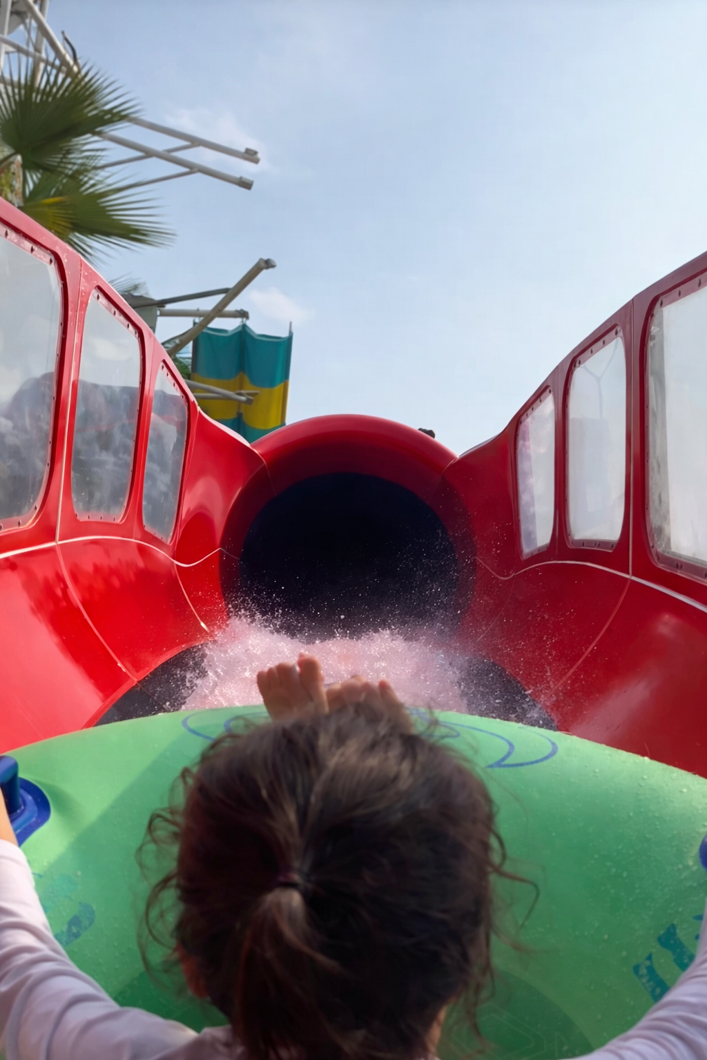 Small kid in an inner tube on a water coaster