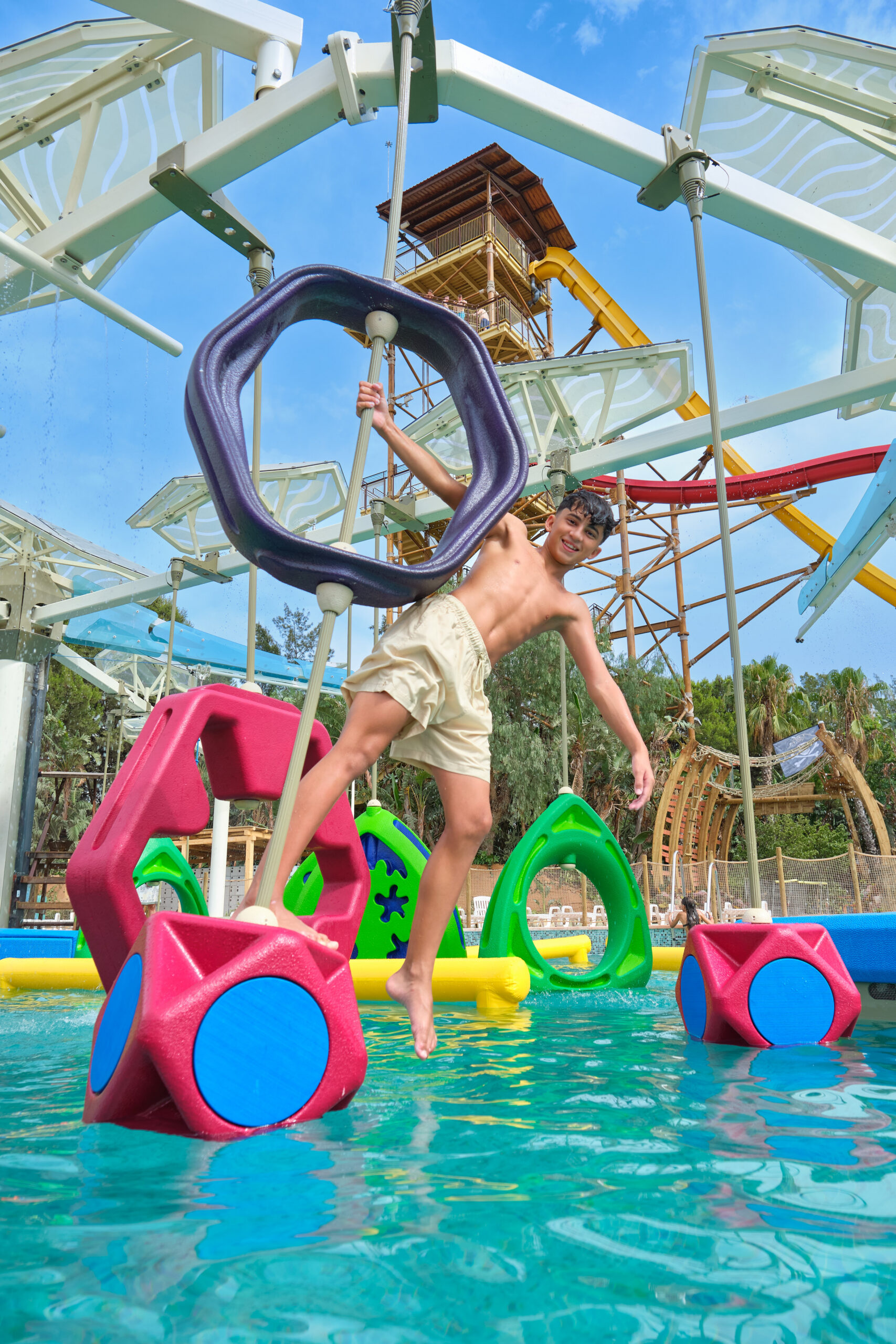 A boy on an aquatic obstacle course