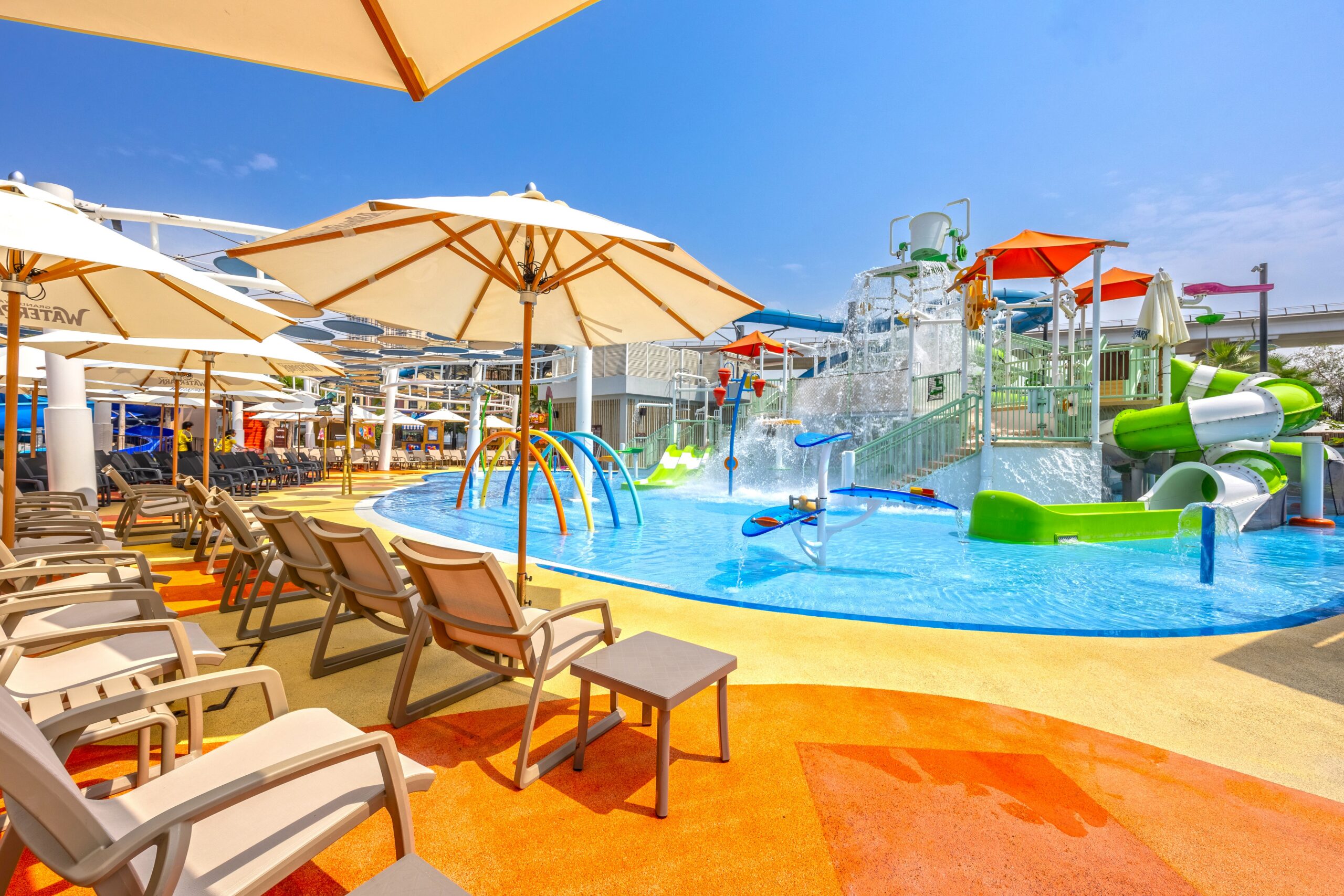 Lounger chairs facing an aquatic play structure