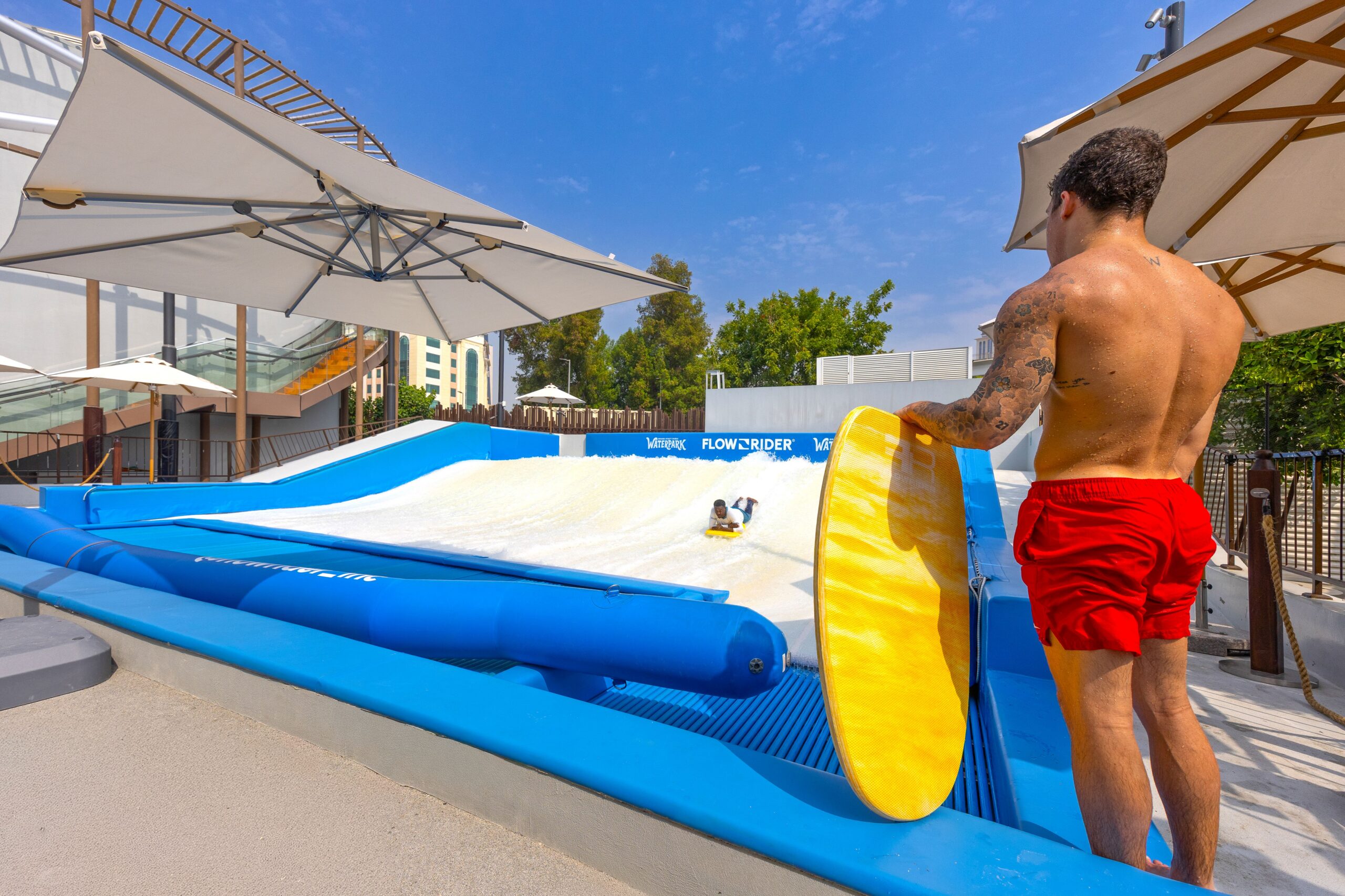 A man watching a flowboarder